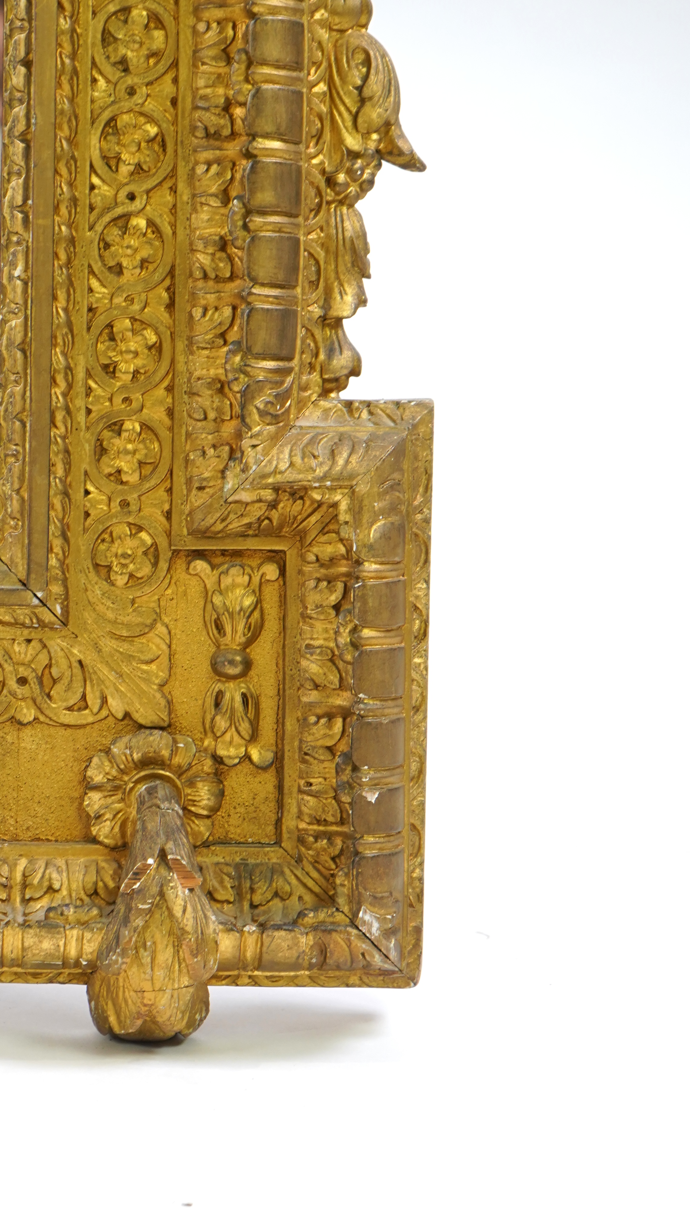 A late 19th century French carved gilt wood and composition overmantel mirror